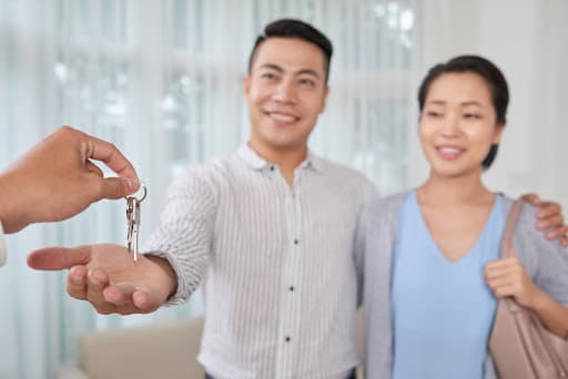 couple being given house keys after home purchase